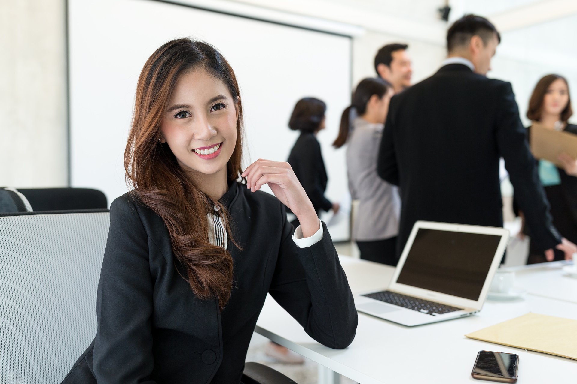 Smiling Businesswoman Attending Meeting